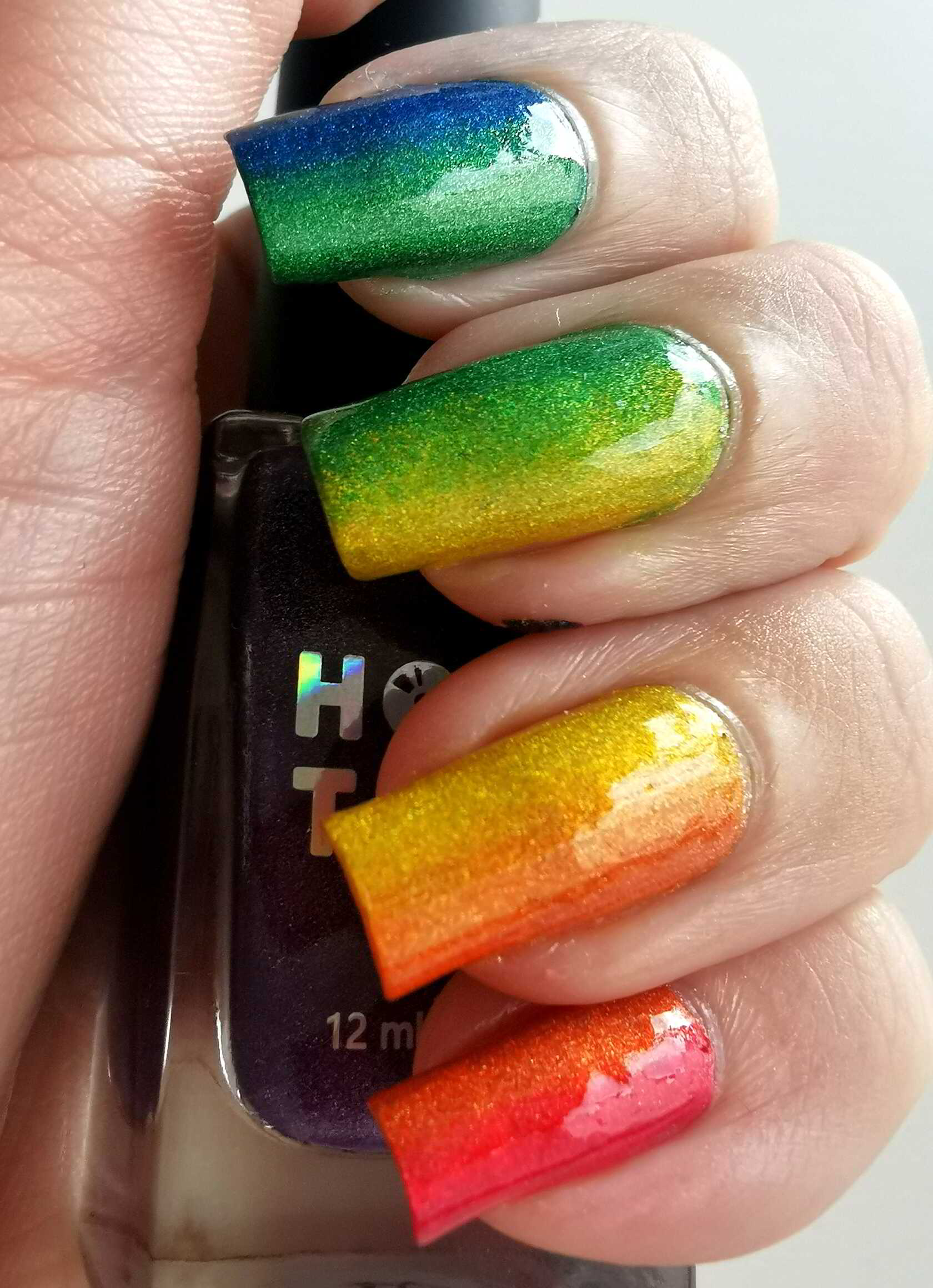 Nail polish manicure of shade Holo Taco Red Licorice, Holo Taco Orange Drink,Holo Taco Lemon Sucker,Holo Taco Green Taffy,Holo Taco Blue Freezie