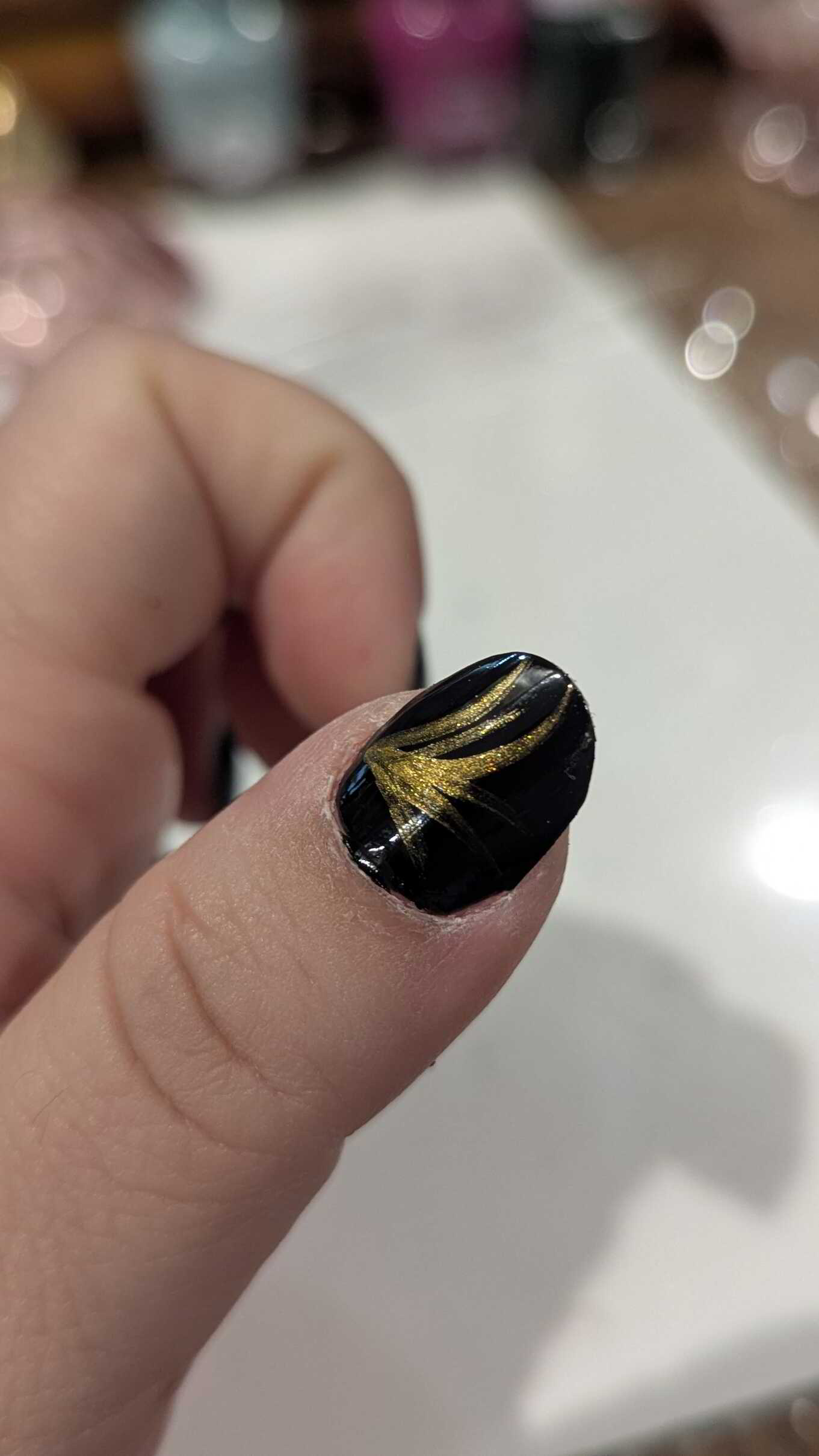 Nail polish manicure of shade Sally Hansen Back to Black, Revlon Vincent Van Gold