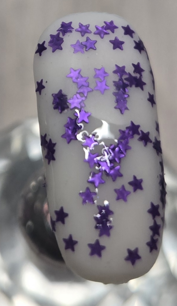 Nail polish swatch / manicure of shade Fancy Gloss Purple Mini Stars