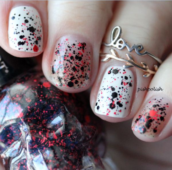 Nail polish swatch / manicure of shade Blackheart Black Base Red Splatter