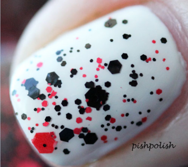 Nail polish swatch / manicure of shade Blackheart Black Base Red Splatter